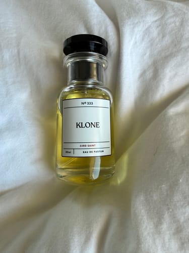 Customer's bottle of 33rd Saint eau de parfum sitting on a white fabric surface.